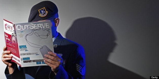 A gay member of the US Air Force who chooses to not be identified reads a copy of the new magazine 'OutServe' intended for ac