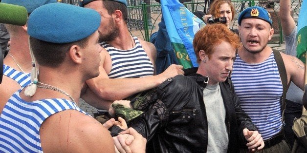 Russian paratroopers scuffle with gay right activist Kirill Kalugin (C), who stood protesting against gay rights violations at the Dvortsovaya square in St. Petersburg on August 2, 2013 during the celebration of the Day of Paratroops. AFP PHOTO / OLGA MALTSEVA (Photo credit should read OLGA MALTSEVA/AFP/Getty Images)