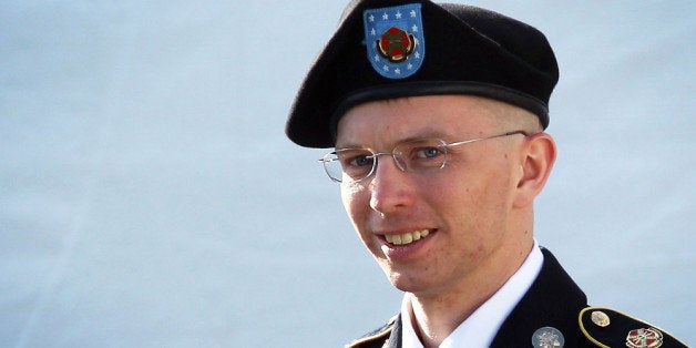FORT MEADE, MD - JUNE 06: U.S. Army Private Bradley Manning is escorted as he leaves a military court at the end of the firs