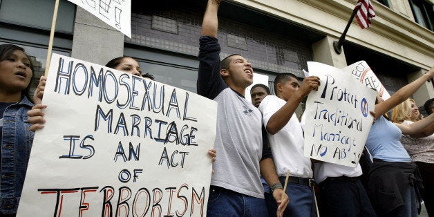 LOS ANGELES - MAY 18: Demonstrators hold sign reading, 'homosexual marriage is an act of terrorism' as they chant slogans against same-sex marriages at an anti-gay rally on May 18, 2004 in Los Angeles, California. Massachusetts became the first state to legalize same-sex marriages yesterday prompting fears among the mostly-religious gathering that California might do the same. (Photo by David McNew/Getty Images)