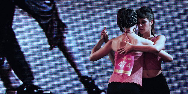 The couple Marlene Heyman (R) and Lucia Christe perform during the qualification round of the Tango World Tournament in Buenos Aires on August 20, 2013. For the first time in eleven editions leading the tournament in Buenos Aires, the audience observed the skills of same-sex dancers couples. AFP PHOTO / DANIEL GARCIA (Photo credit should read DANIEL GARCIA/AFP/Getty Images)