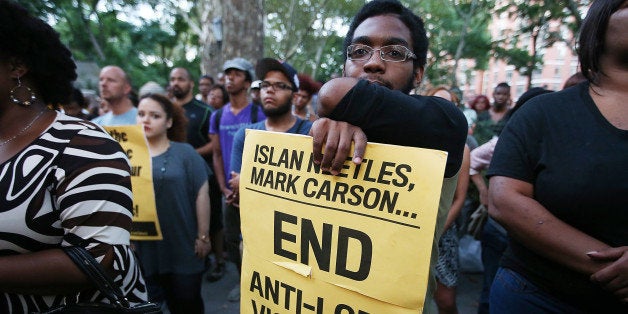 NEW YORK, NY - AUGUST 27: People gather at a vigil for slain transgender woman Islan Nettles at Jackie Robinson Park in Harlem on August 27, 2013 in New York City. Nettles was severely beaten two weeks ago after being approached on the street by a group of men and later died of her injuries. (Photo by Mario Tama/Getty Images)