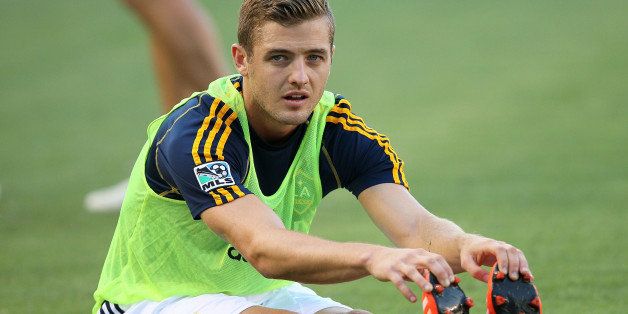 LOS ANGELES, CA - JULY 04: Robbie Rogers #14 of the Los Angeles Galaxy stretches during warm-up prior to the MLS match between the Columbus Crew and the Los Angeles Galaxy at StubHub Center on July 4, 2013 in Los Angeles, California. The Galaxy defeated the Crew 2-1. (Photo by Victor Decolongon/Getty Images) 