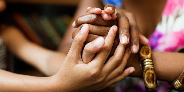 Mother and daughter holding hands in cafe