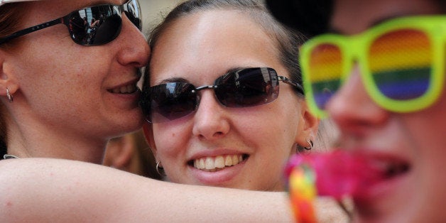 People take part in the gays, lesbians, bisexuals and supporters of equal rights for sexual minorities march, the Europride parade, at the Vieux Port on July 20, 2013 in Marseille, southern France. AFP PHOTO / ANNE-CHRISTINE POUJOULAT (Photo credit should read ANNE-CHRISTINE POUJOULAT/AFP/Getty Images)