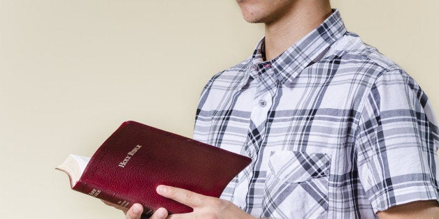 young man standing and reading...