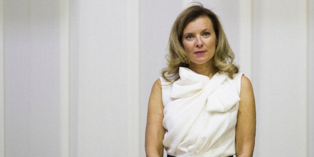 Valerie Trierweiler, partner of French President stands as she listens national anthems during a state dinner with South African president on October 14, 2013 in Pretoria. On a two-day state visit to South Africa, Hollande told that an agreement has been penned between French energy firm 'GDF Suez and South Africa for a thermal power plant to the tune of 1,5 billion euros and also for a solar plant.' AFP PHOTO / FRED DUFOUR (Photo credit should read FRED DUFOUR/AFP/Getty Images)