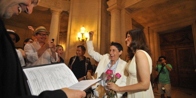 Same-sex couple Jen and Francis Rainin react during their wedding at San Francisco's City Hall in California on Friday, June 28, 2013. The 9th Circuit Court lifted the stay on same-sex marriage in California, immediately sending a flurry of soon-to-be married couples to City Hall. AFP Photo/JOSH EDELSON (Photo credit should read Josh Edelson/AFP/Getty Images)