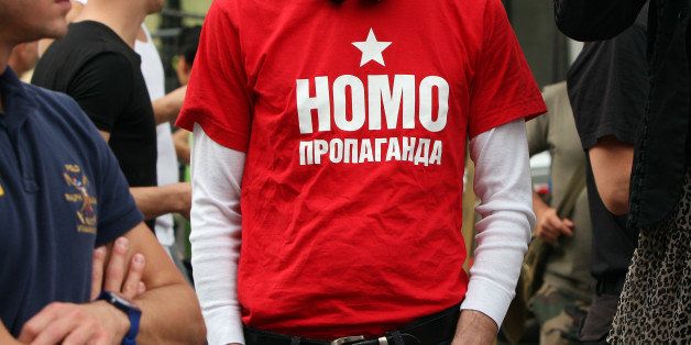 BERLIN, GERMANY - SEPTEMBER 08: A participant wears a t-shirt reading 'Homo Propaganda' in Russian as he demonstrates in front of the Russian Embassy during the 'To Russia With Love' Global Kiss-In on September 8, 2013 in Berlin, Germany. The event was designed to show international solidarity with homosexuals in Russia, currently under pressure from with what is considered by some in societies with more liberal gay rights policies to be homophobic legislation. (Photo by Adam Berry/Getty Images)
