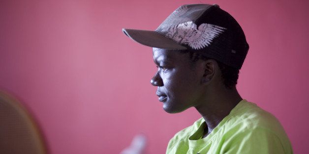 Lindeka Stulo, a lesbian woman who has been assaulted four times as a result of her sexual orientation talks about her experiences at Ithemba Lam, a township gay rights Christian centre and safe house on January 19, 2012 in Gugulethu, an impoverished township about 15Km of Cape Town. After being assaulted on one occasion she was hospitalised for a month. Stulo fears 'Corrective' rape as it is called, which aims to turn lesbians heterosexual, and is a not uncommon danger for lesbians in the largely patriachial communities found in many South African townships. AFP PHOTO/ RODGER BOSCH ***TO GO WITH AFP STORY BY JUSTINE GERARDY*** (Photo credit should read RODGER BOSCH/AFP/Getty Images)