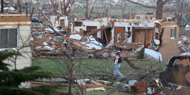 WASHINGTON, IL - NOVEMBER 18: A man walks amongst damaged buildings along Washington Road in the aftermath of a tornado on November 18, 2013 in Washington, Illinois. A fast-moving storm system that produced several tornadoes that touched down across the Midwest left behind a path of destruction in 12 states. (Photo by Tasos Katopodis/Getty Images)