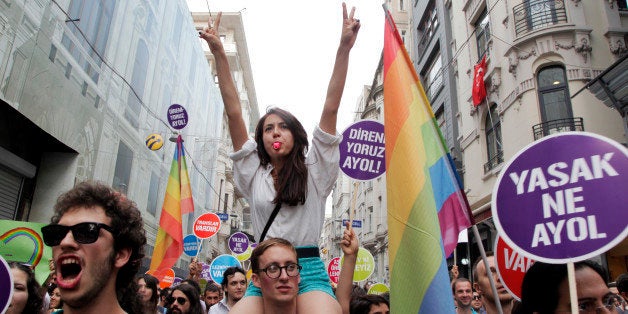 People march and chant slogans during a gay parade on Istiklal Street, the main shopping corridor on June 30, 2013 in Istanbul during the fourth Trans Pride Parade as part of the Trans Pride Week 2013, which is organized by Istanbul's 'Lesbians, Gays, Bisexuals, Transvestites and Transsexuals' (LGBTT) solidarity organization. AFP PHOTO/GURCAN OZTURK (Photo credit should read GURCAN OZTURK/AFP/Getty Images)