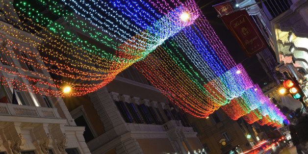 Picture of Christmas lights taken in the Via del Corso, one of the main shopping street of Rome, on December 6, 2013. This year the illuminations are 'gay-friendly' with a rainbow of colors enveloping the street. The six strips that change color from red to purple, symbol of the traditional 'rainbow flag' and an expression of the homosexual movement, will make up the bright carpet of a mile and a half to get to Piazza Venezia to Piazza del Popolo. After the tricolor of 2011, on the occasion of the 150th anniversary of the Unification of Italy, and those white monochrome of 2012, Rome wants to send a message and stand in the front row as the capital of rights. AFP PHOTO / GABRIEL BOUYS (Photo credit should read GABRIEL BOUYS/AFP/Getty Images)