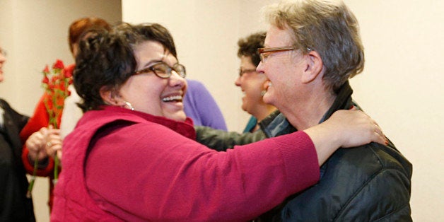 PROVO, UT - DECEMBER 20: Jennifer Munson, (L) hands a flower to Arlene Arnold, (R) outside the offices of the Utah County Clerk and Auditor office after Arlene received a rejection letter for a marriage license on July 20, 2013 in Provo, Utah. A Federal Judge on December 20, struck down Utah's ban on same sex marriage saying the law violates the U.S. Constitution. While the ban was lifted and officials were reportedly issuing licenses in Salt Lake City, officials in Provo were denying applicants. (Photo by George Frey/Getty Images)