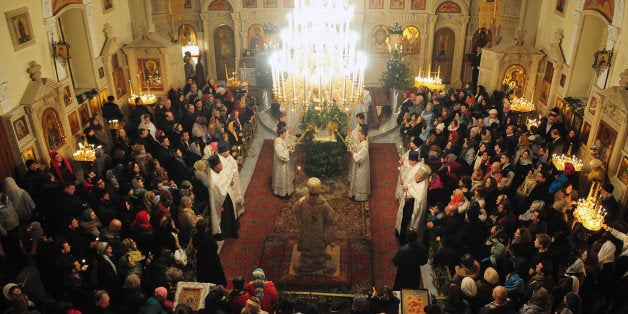 People attend a Christmas service in Baku early on January 7, 2014. Orthodox Christians celebrate Christmas on January 7 in the Middle East, Russia and other Orthodox churches that use the old Julian calendar instead of the 17th-century Gregorian calendar adopted by Catholics, Protestants, Greek Orthodox and commonly used in secular life around the world. AFP PHOTO / TOFIK BABAYEV (Photo credit should read TOFIK BABAYEV/AFP/Getty Images)