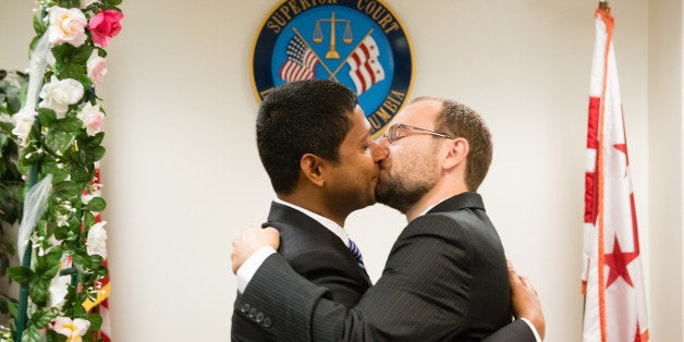 WASHINGTON, DC - SEPTEMBER 16: The Marriage Bureau of D.C. Superior Court has expanded to handle the increased demand after the same-sex ruling. Stephen Donahoe, 27, left and Ranajoy Ray Chaudhuri, 37, kiss after being married in a civil ceremony. They live in DC. Photo by Sarah L. Voisin/The Washington Post via Getty Images)