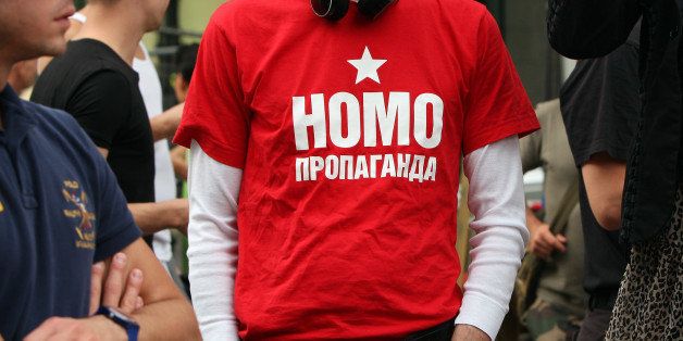 BERLIN, GERMANY - SEPTEMBER 08: A participant wears a t-shirt reading 'Homo Propaganda' in Russian as he demonstrates in front of the Russian Embassy during the 'To Russia With Love' Global Kiss-In on September 8, 2013 in Berlin, Germany. The event was designed to show international solidarity with homosexuals in Russia, currently under pressure from with what is considered by some in societies with more liberal gay rights policies to be homophobic legislation. (Photo by Adam Berry/Getty Images)
