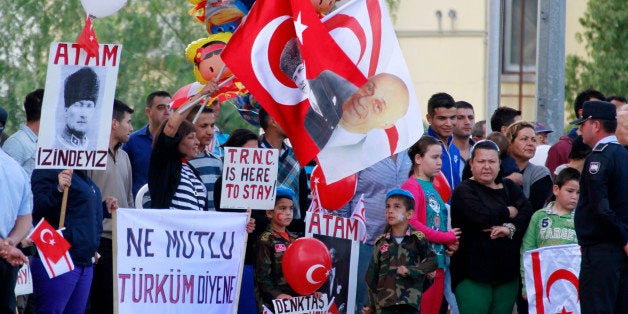 People attend the celebrations of the 30th anniversary of the declaration of the Turkish Republic of Northern Cyprus (TRNC) in the Turkish-occupied sector of Nicosia in the self-proclaimed state on November 15, 2013. The island of Cyprus has been divided since the 1974 Turkish invasion which was followed by the declaration of the breakaway state in the Turkish-occupied north in 1983. AFP PHOTO/BIROL BEBEK (Photo credit should read Birol Bebek/AFP/Getty Images)