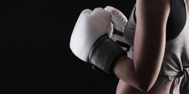 woman boxer on black background