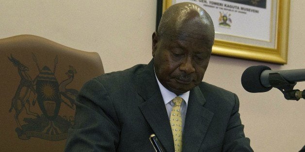 Ugandas President Yoweri Museveni signs the Anti-Homosexuality Bill on February 24, 2014 in Entebbe. The bill that was first