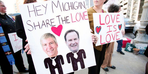 DETROIT, MI - OCTOBER 16: People in favor of same-sex marriage rally at the U.S. Courthouse where U.S. District Judge Bernard Friedman will hold a hearing today that could overturn Michigan's ban on same-sex marriage October 16, 2013 in Detroit, Michigan. The lawsuit was brought by April DeBoer and Jayne Rowse, a gay couple who are raising three adopted children together. Michigan passed a constitutional amendment in 2004 that defined marriage as being between a man and a woman. (Photo by Bill Pugliano/Getty Images)