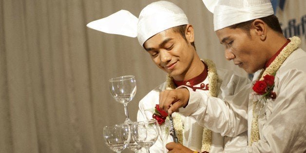 Tin Ko Ko (CR) and Myo Min Htet (CL) are celebrating the wedding reception at Yangon on March 2 , 2014. This is first ever Gay couple marriage publicly in Myanmar. AFP PHOTO (Photo credit should read Ye Aung Thu/AFP/Getty Images)