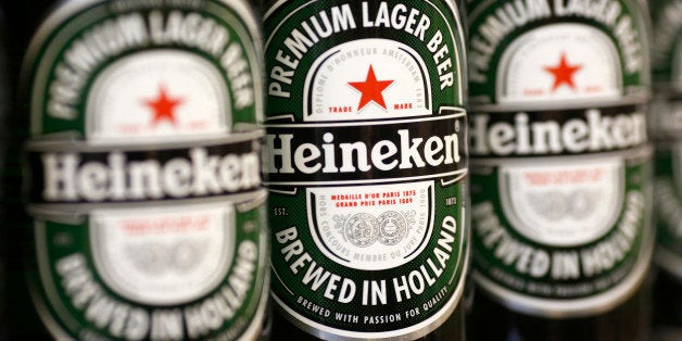 Bottles of Heineken lager, produced by Heineken NV, sit displayed for sale inside a supermarket in London, U.K., on Tuesday, Feb. 11, 2014. The pound rose to a one-week high against the dollar after an industry report showed U.K. retail sales growth accelerated in January, adding to evidence the recovery is gaining momentum. Photographer: Simon Dawson/Bloomberg via Getty Images