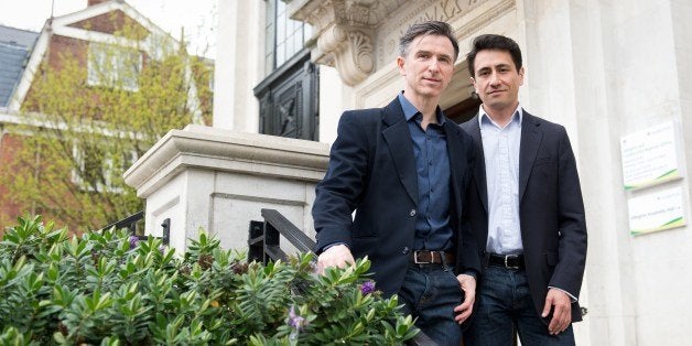 Peter McGraith (L) and David Cabreza pose for photographs at Islington Town Hall in north London on March 25, 2014. The coup