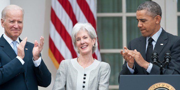 US President Barack Obama (R) and Vice President Joe Biden (L) applaud outgoing Heath and Human Services Secretary Kathleen Sebelius as Obama names Sylvia Mathews Burwell, his current budget director, to replace her in the Rose Garden at the White House in Washington,DC on April 11, 2014. Sebelius resigned, paying the price for the chaotic initial rollout of the US president's signature health care law. AFP PHOTO/Nicholas KAMM (Photo credit should read NICHOLAS KAMM/AFP/Getty Images)