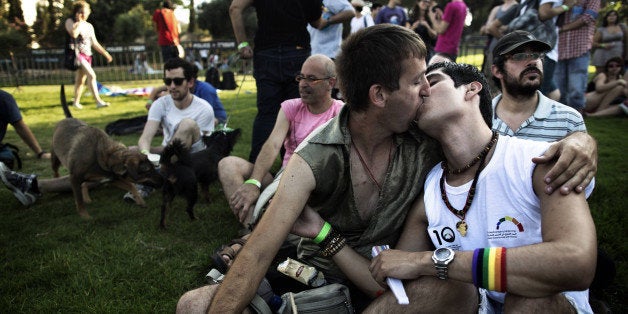 Two Israeli's kiss as they participate in the 10th anniversary Gay Pride Parade in Jerusalem on August 2, 2012. Opposition to such events is fiercer in Jerusalem, where religious feelings can run high, than in the more laid-back seaside city of Tel Aviv, but police were out in force to keep the peace. AFP PHOTO/MENAHEM KAHANA (Photo credit should read MENAHEM KAHANA/AFP/GettyImages)