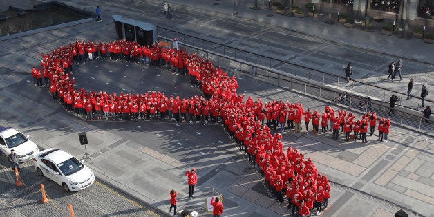 SEOUL, SOUTH KOREA - DECEMBER 01: South Korean students pose in the shape of the 'aids ribbon' during an event to promote th