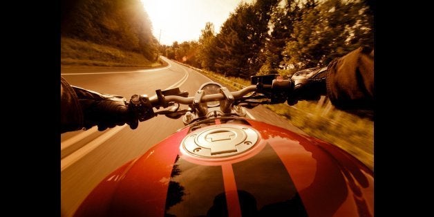 Riding motorcycle on country road in the sunset. Some lens flares. Shot wide angle with 5DII.