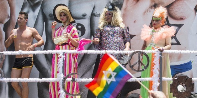 Israeli drag queens and go-go dancers dance on a truck during the annual gay pride parade in the Israeli coastal city of Tel Aviv on June 13, 2014. AFP PHOTO/JACK GUEZ (Photo credit should read JACK GUEZ/AFP/Getty Images)