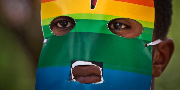 FILE - In this Monday, Feb. 10, 2014 file photo, a Kenyan gay wears a mask to preserve his anonymity as they stage a rare protest, against Uganda's increasingly tough stance against homosexuality and in solidarity with their counterparts there, outside the Uganda High Commission in Nairobi, Kenya Monday, Feb. 10, 2014. Ugandan President Yoweri Museveni met in his office with a team of U.S.-based rights activists concerned about legislation that would impose life sentences for some homosexual acts and made clear he had no plans to sign the bill, according to Santiago Canton of the Robert F. Kennedy Center for Justice and Human Rights who attended the Jan. 18, 2014 meeting, but one month later Museveni appears to have changed his mind, saying through a spokesman in February 2014 that he would sign the bill "to protect Ugandans from social deviants." (AP Photo/Ben Curtis, File)