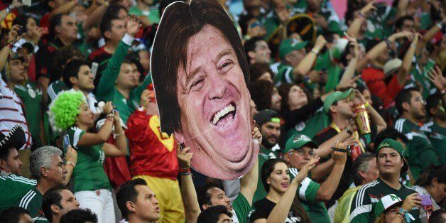 Mexico's fans hold up a cardboard cutout of Mexico's coach Miguel Herrera during a Group A football match between Croatia and Mexico at the Pernambuco Arena in Recife during the 2014 FIFA World Cup on June 23, 2014. AFP PHOTO / YURI CORTEZ (Photo credit should read YURI CORTEZ/AFP/Getty Images)