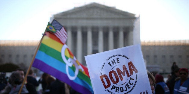 WASHINGTON, DC - MARCH 27: People carry banners and flags during a rally in front of the U.S. Supreme Court, on March 27, 2013 in Washington, DC. Today the high court is scheduled to hear arguments on whether Congress can withhold federal benefits from legally wed gay couples by defining marriage as only between a man and a woman. (Photo by Mark Wilson/Getty Images)