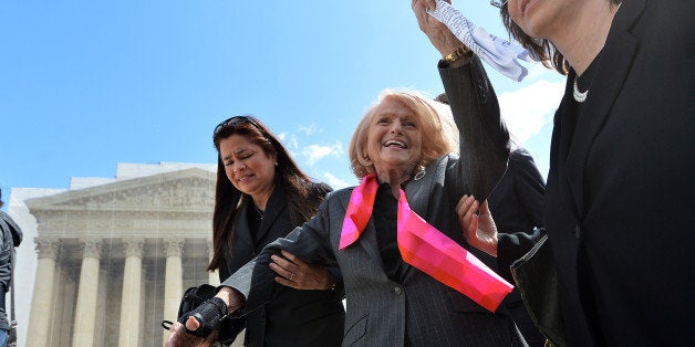 Plaintiff of the US v. Windsor case challenging the constitutionality of Section 3 of the Defense of Marriage Act (DOMA), 83-year-old lesbian widow Edie Windsor (C), greets same-sex marriage supporters as she leaves the Supreme Court on March 27, 2013 in Washington, DC. The US Supreme Court tackled same-sex unions for a second day Wednesday, hearing arguments for and against the 1996 US law defining marriage as between one man and one woman. After the nine justices mulled arguments on a California law outlawing gay marriage on Tuesday, they took up a challenge to the constitutionality of the federal Defense of Marriage Act (DOMA). The 1996 law prevents couples who have tied the knot in nine states -- where same-sex marriage is legal -- from enjoying the same federal rights as heterosexual couples. AFP PHOTO/Jewel Samad (Photo credit should read JEWEL SAMAD/AFP/Getty Images)