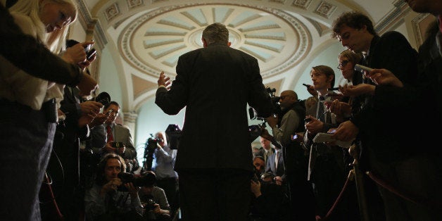 WASHINGTON, DC - NOVEMBER 05: Senate Majority Leader Harry Reid (D-NV) (C) talks with reporters after attending the weekly Senate Democratic Caucus policy luncheon at the U.S. Capitol November 5, 2013 in Washington, DC. The Senate overcame a procedural hurdle Monday to move closer to passage of the Employment Non-Discrimination Act of 2013, which would outlaw workplace discrimination based on sexual orientation and gender identity. (Photo by Chip Somodevilla/Getty Images)