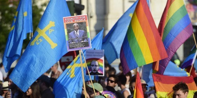 A picture taken on July 5, 2014 shows a placard depicting Uganda's Foreign Minister Sam Kutesa during the Gay Pride Parade in Madrid. Crowds of revellers in elaborate costumes filled the streets of central Madrid today in what organisers billed the biggest gay pride parade in Europe. Organisers expected more than a million people at the evening parade, the main event in five days of festivities by defenders of lesbian, gay, bisexual and transgender (LGBT) rights. AFP PHOTO / PIERRE-PHILIPPE MARCOU (Photo credit should read PIERRE-PHILIPPE MARCOU/AFP/Getty Images)