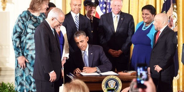 US President Barack Obama signs an Executive Order to protect LGBT (lesbian, gay, bisexual, and transgender) employees from workplace discrimination in the East Room at the White House in Washington, DC, on July 21, 2014. AFP PHOTO/Jewel Samad (Photo credit should read JEWEL SAMAD/AFP/Getty Images)