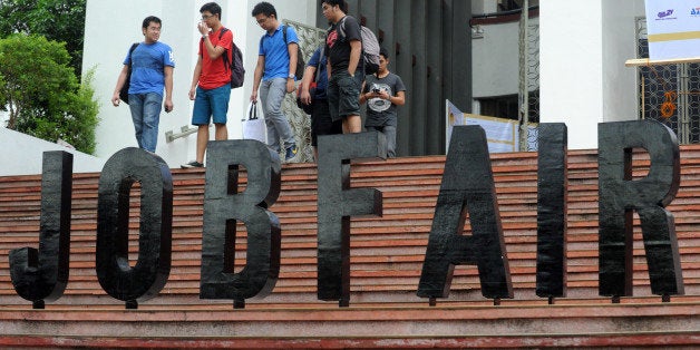 Job seekers attend a job fair at the College of Engineering at the University of the Philippines in Manila on January 16, 2014. The Philippines, one of the world's top labour-exporting nations, is suffering shortages in more than one hundred occupations and is considering proposals to hire skilled foreign workers, officials said on January 16. AFP PHOTO / Jay DIRECTO (Photo credit should read JAY DIRECTO/AFP/Getty Images)