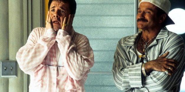 Nathan Lane and Robin Williams standing in pajamas on the porch in a scene from the film 'The Birdcage', 1996. (Photo by United Artists/Getty Images)