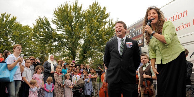 WOODBRIDGE, VA - OCTOBER 16: Reality telvision celebrities, Jim Bob Duggar, center, and his wife, Michelle Duggar make a stop on their 'Values Bus Tour' outside Heritage Baptist Church on Wednesday October 16, 2013 in Woodbridge, VA. (Photo by Matt McClain/ The Washington Post via Getty Images)