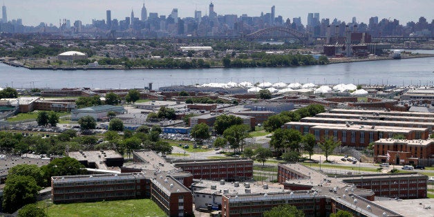 FILE- This June 20, 2014 file photo shows the Rikers Island jail with the New York skyline in the background. Over the past five years, there have been three deaths in New York City's jails in which inmates were alleged to have been fatally beaten by guards. Yet in none of those cases was anyone ever charged with a crime. (AP Photo/Seth Wenig, File)