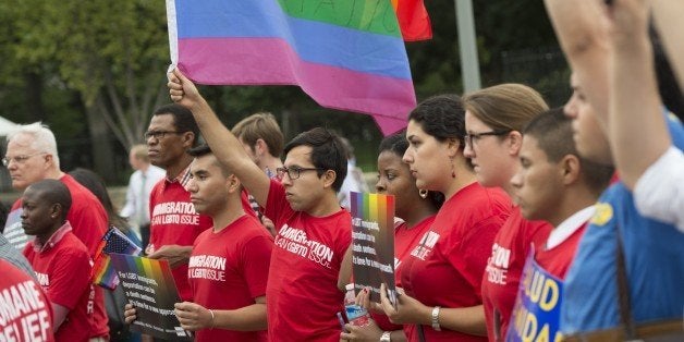 Demonstrators with the group GetEQUAL hold a protest with lesbian, gay, bisexual and transgender (LGBT) individuals affected by the country's immigration policies during a rally outside the White House in Washington, DC, September 9, 2014. AFP PHOTO / Saul LOEB (Photo credit should read SAUL LOEB/AFP/Getty Images)