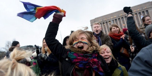 Supporters of the same-sex marriage celebrate outside the Finnish Parliament in Helsinki, Finland on November 28, 2014 after the Finnish parliament approved a bill allowing homosexual marriage. AFP PHOTO /Lehtikuva/ MIKKO STIG*** FINLAND OUT *** (Photo credit should read MIKKO STIG/AFP/Getty Images)