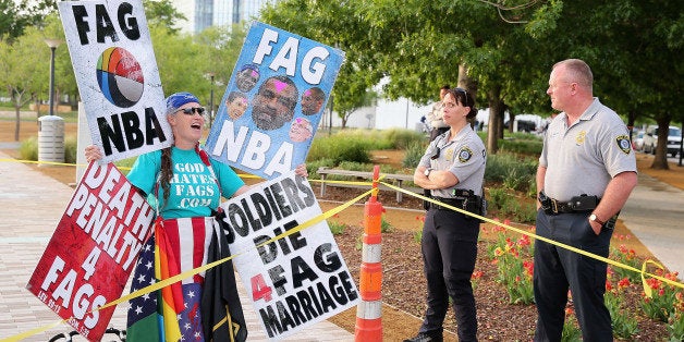 OKLAHOMA CITY, OK - MAY 01: A member of the Westboro Baptist Church protests gay rights and the NBA as police officers look on before Game Five of the Western Conference Quarterfinals of the 2013 NBA Playoffs between the Oklahoma City Thunder and the Houston Rockets outside of Chesapeake Energy Arena on May 1, 2013 in Oklahoma City, Oklahoma. NOTE TO USER: User expressly acknowledges and agrees that, by downloading and or using this photograph, User is consenting to the terms and conditions of the Getty Images License Agreement. (Photo by Christian Petersen/Getty Images)