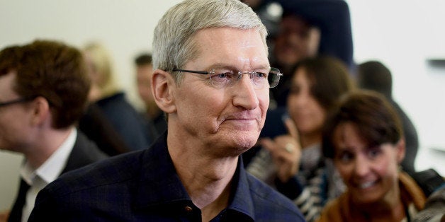 Tim Cook, chief executive officer of Apple Inc., speaks with members of the media after a product announcement in Cupertino, California, U.S., on Thursday, Oct. 16, 2014. Apple Inc. unveiled a new iPad, in the second wave of Cook's biggest product push as chief executive officer and just ahead of the holiday shopping season. Photographer: Noah Berger/Bloomberg via Getty Images 