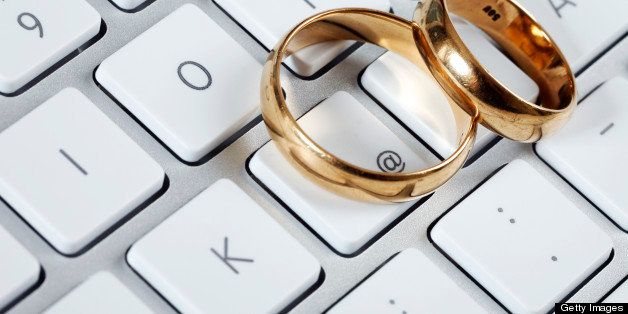 Wedding Rings on Computer Keyboard as Online Dating Concept.