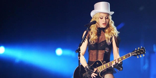 American singer Madonna performs onstage at the Cardiff Millennium Stadium on August 23, 2008 during the first concert of her 'Sticky and Sweet' world tour. The US star was to play hits including 'Like A Prayer', 'Into The Groove' and 'Hung Up' at the 75,000 capacity Millenium Stadium in Cardiff, Wales on the first night of the 49-date tour. AFP PHOTO/Leon Neal (Photo credit should read Leon Neal/AFP/Getty Images)